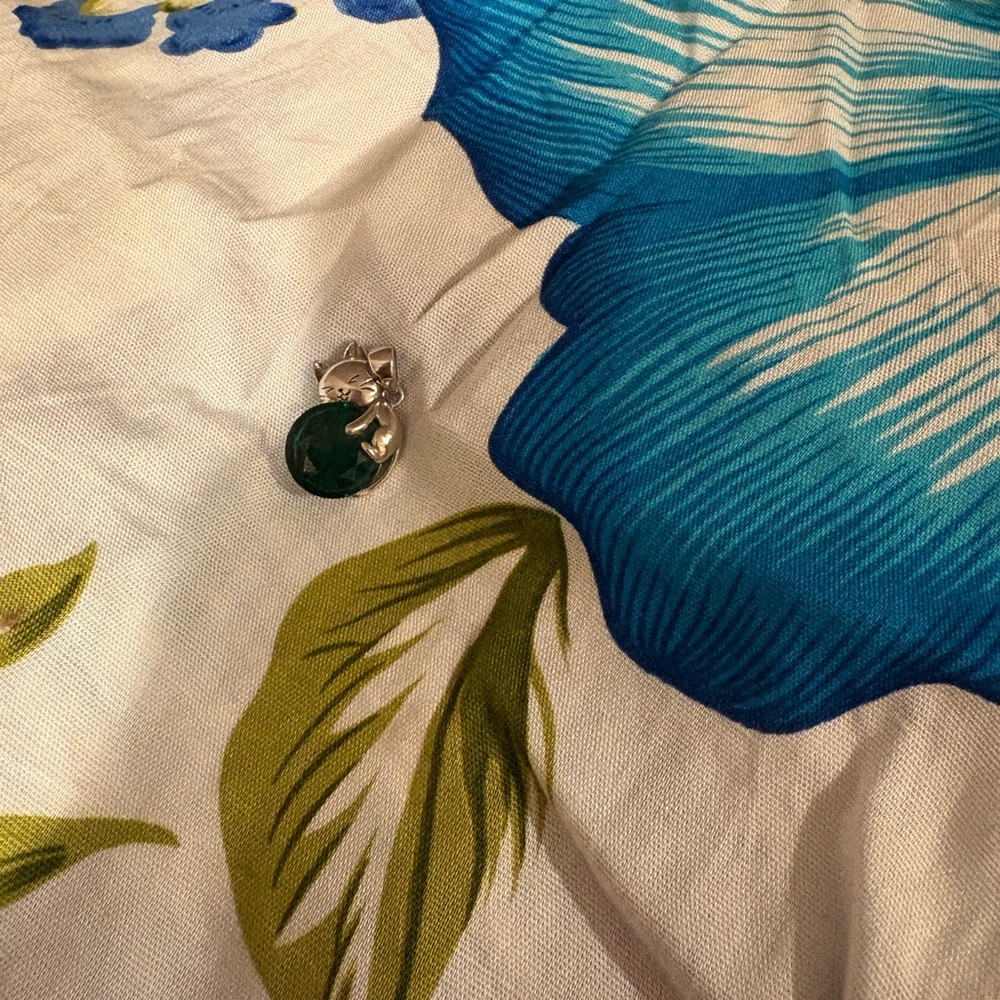 silver cat pendant with large green crystal
